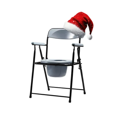 Portable commode chair with padded armrests and removable bucket, humorously decorated with a red Santa hat for a festive holiday touch, photographed indoors against a neutral background.