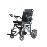A modern electric wheelchair with a black cushioned seat, armrests, and a joystick control on the left armrest. The wheelchair has large rear wheels with a unique tread pattern and smaller front wheels with suspension.
