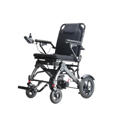 A modern electric wheelchair with a black cushioned seat, armrests, and a joystick control on the left armrest. The wheelchair has large rear wheels with a unique tread pattern and smaller front wheels with suspension.