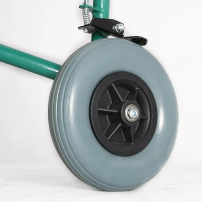 Close-up of a gray rubber caster wheel with a black hub and central bolt, mounted to a green metal frame via a black spring-loaded bracket.