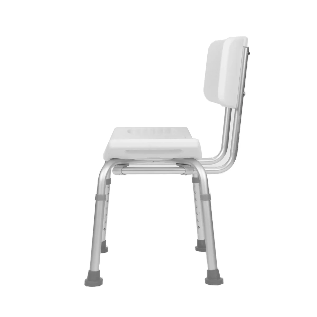 Side view of a white plastic shower chair with a contoured seat, supportive backrest, and height-adjustable metal legs ending in rubber tips.