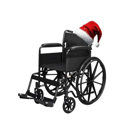 A black manual wheelchair with a festive red Santa hat placed on the backrest, set against a plain white background for a cheerful holiday look.
