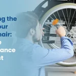 A person performing routine maintenance on a manual wheelchair, checking the tire pressure with a gauge as part of a simple upkeep checklist to extend the chair's lifespan.